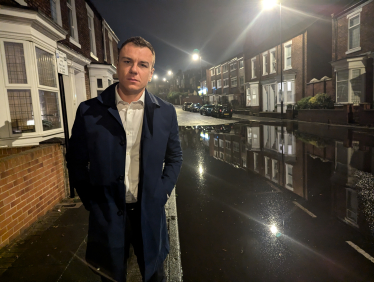 Cllr Lyall Reed on a flooded street in Ashbrooke 